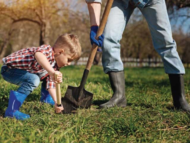 man with shovel digging with little boy