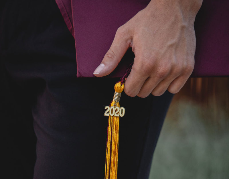 hand holding graduation cap with 2020 tassell